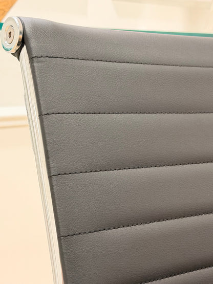 Close up detail of black ribbed leatherette backrest with durable metal chrome rim