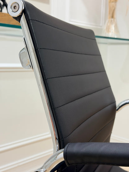Full back view of black ribbed leatherette office chair with chrome frame and handle bar