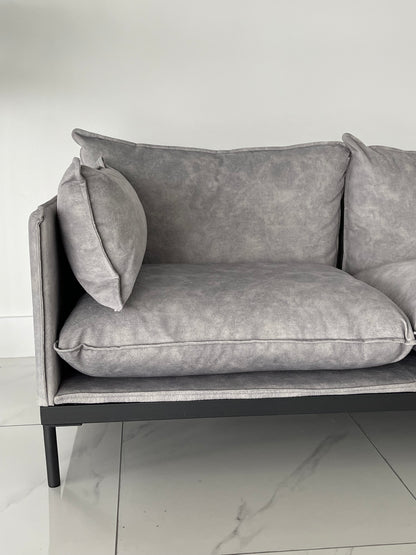 Close up shot of grey fabric upholstery and armrest pillow on modern 2-seater office reception couch