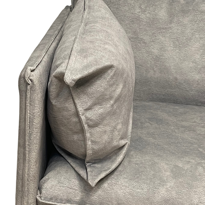 Close-up view of soft plush side cushion and premium grey fabric upholstery on modern office sofa
