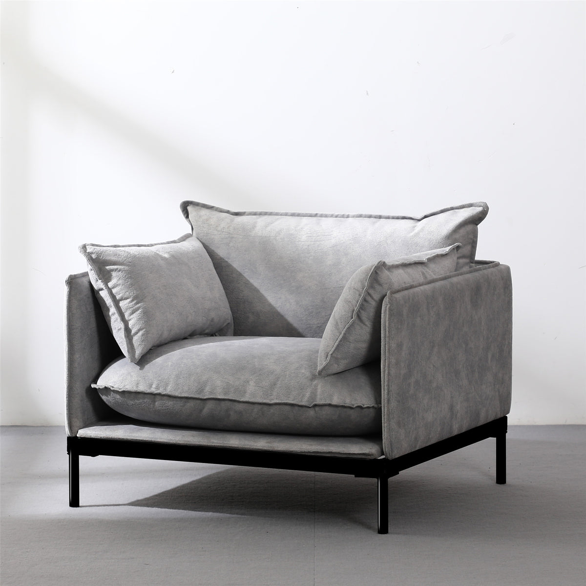 Modern single guest armchair with grey plush cushions and black metal frame for office waiting area