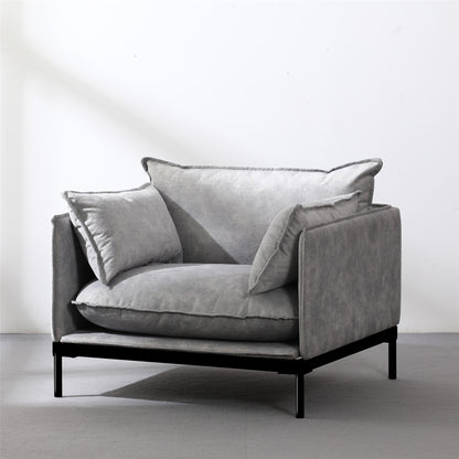 Modern single guest armchair with grey plush cushions and black metal frame for office waiting area
