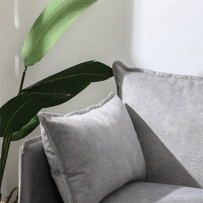 Detailed view of soft side pillow cushion and fabric upholstery on modern grey office reception sofa